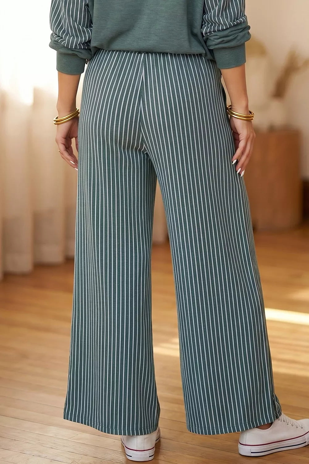 Green raw-seam top and striped pants set, back of pants