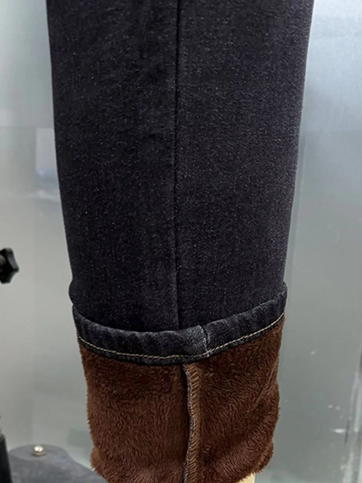Black high-waisted fleece-lined skinny jeans, detail view
