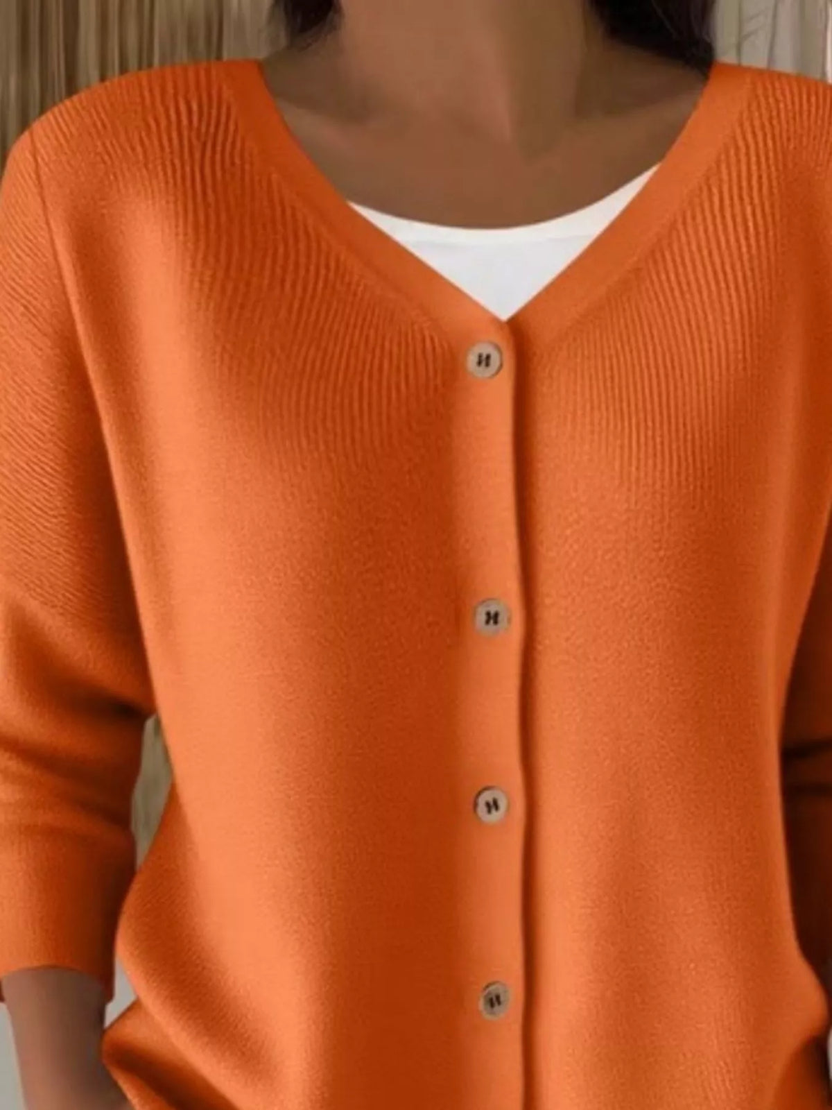 Orange ribbed button-front cardigan, neckline close-up