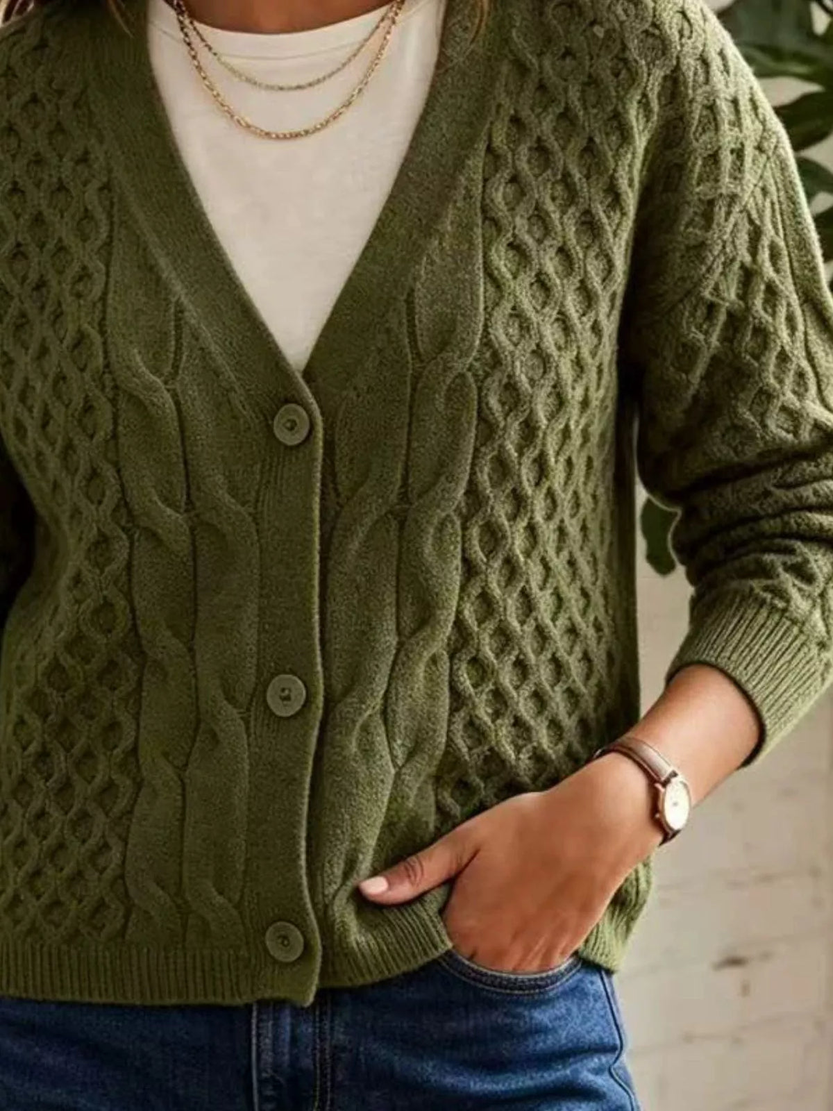 Olive cable-knit v-neck button-front cardigan, cable knit and button detail.
