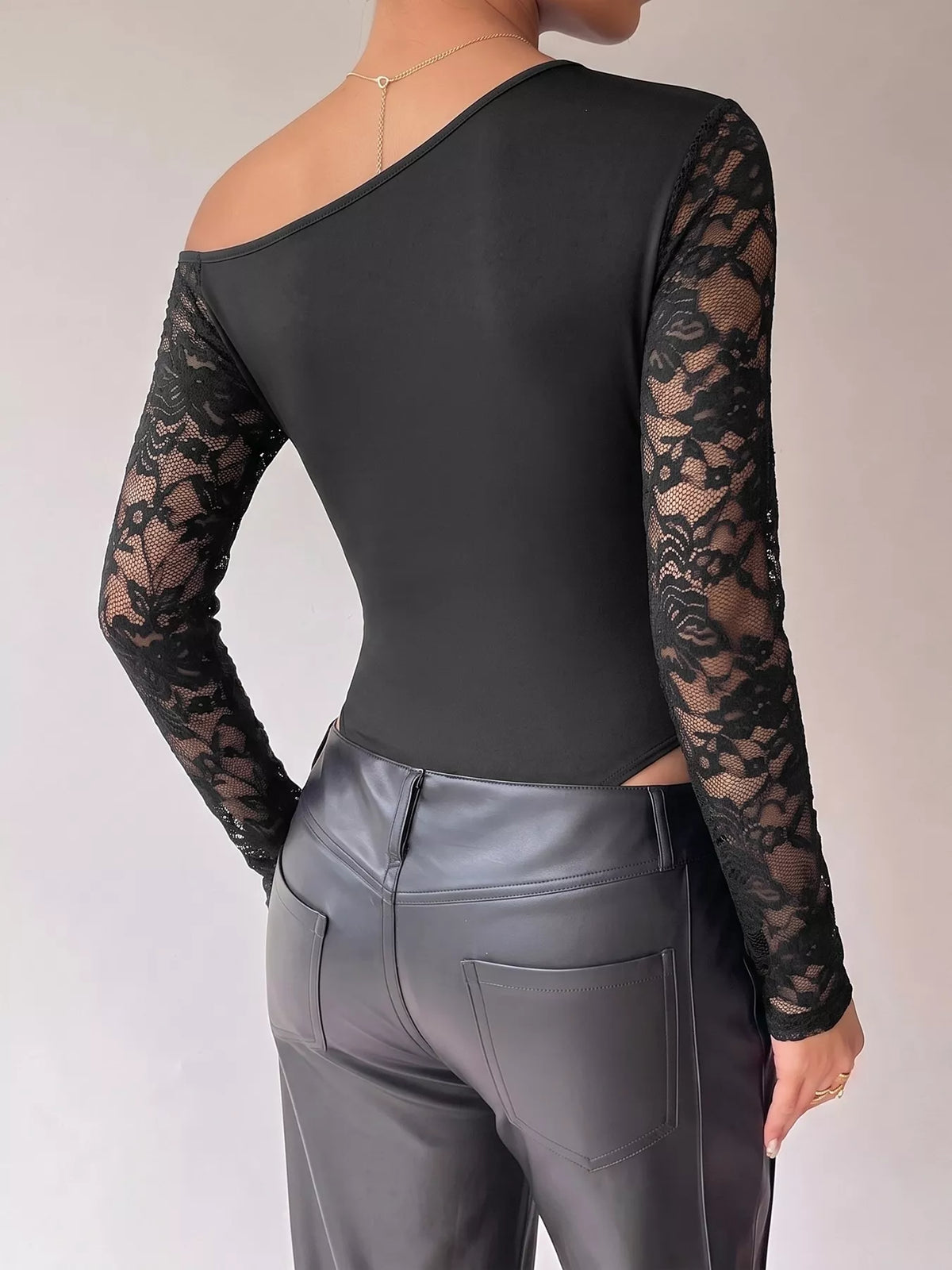 Black lace-sleeve draped bodysuit, back view