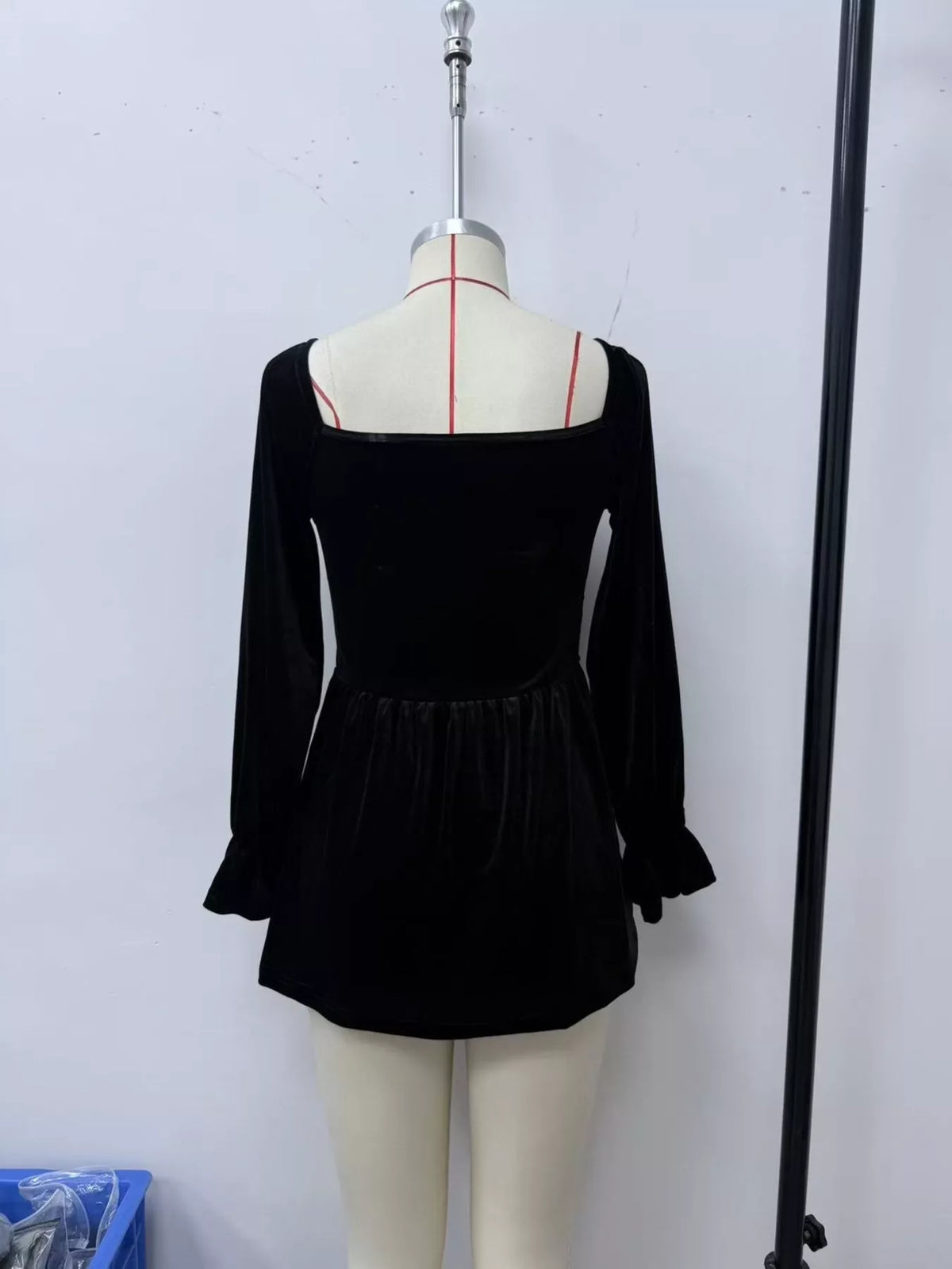 Women's Velvet Smocked Peplum Blouse in Black, back view