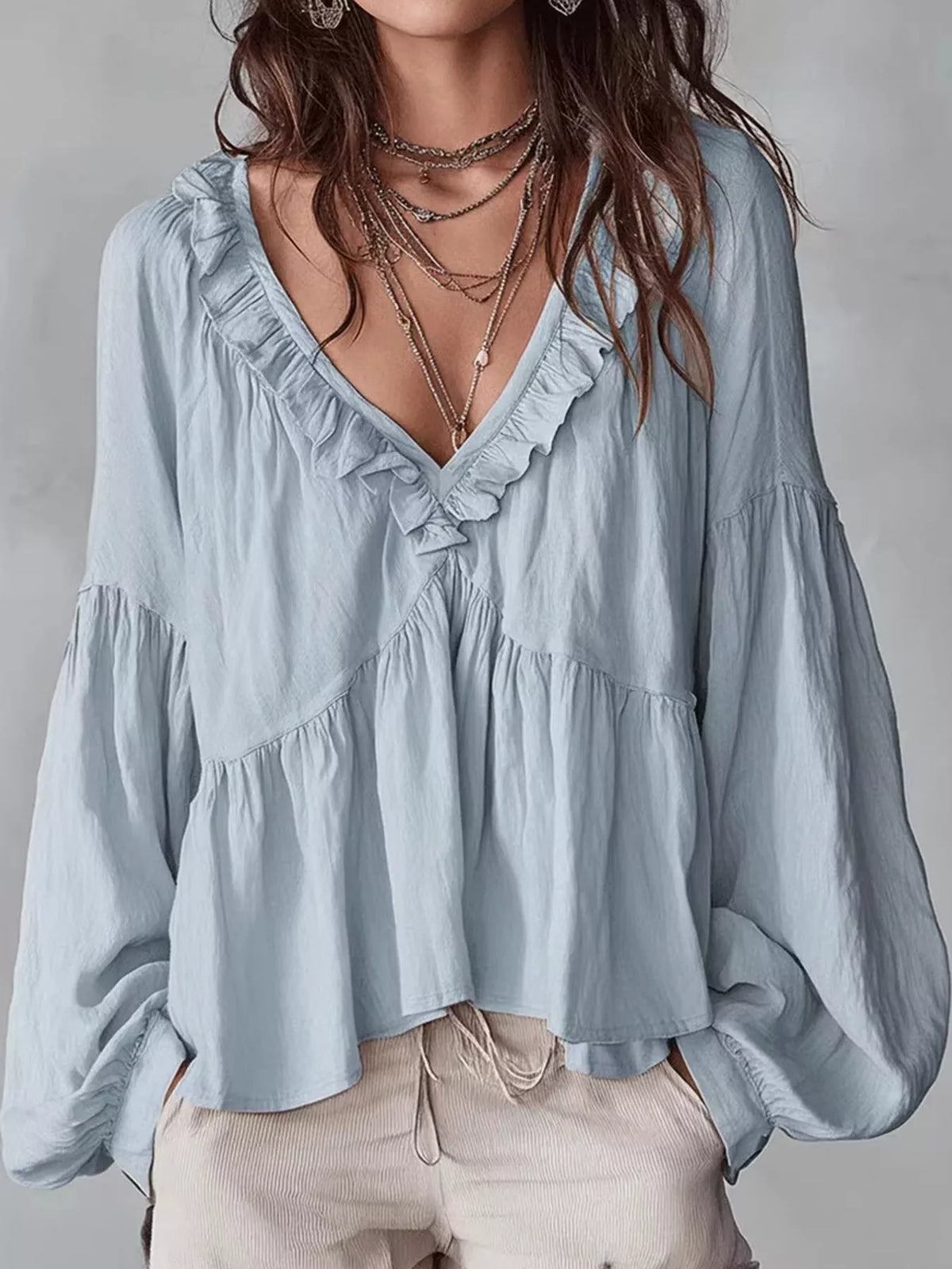 Light blue ruffled v neck blouse, front view