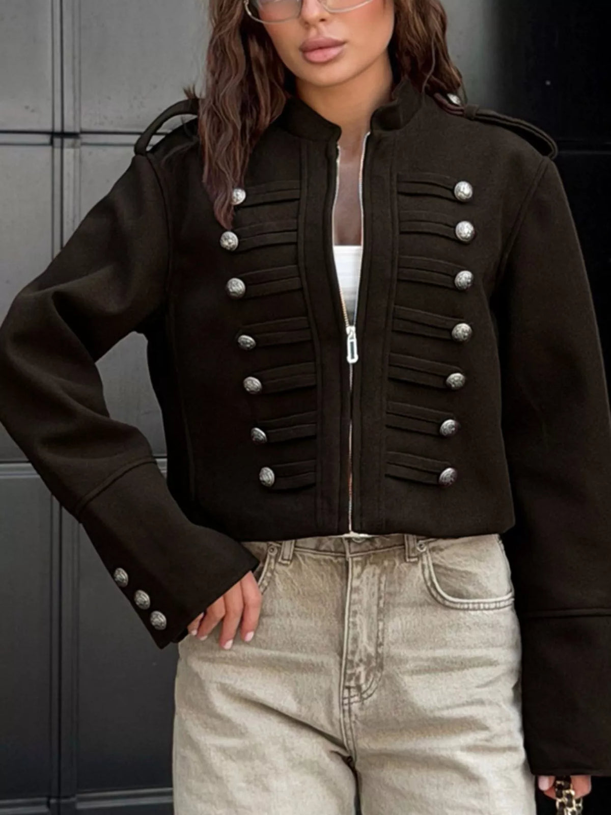 Black cropped zip-front jacket, front view with hand at hip