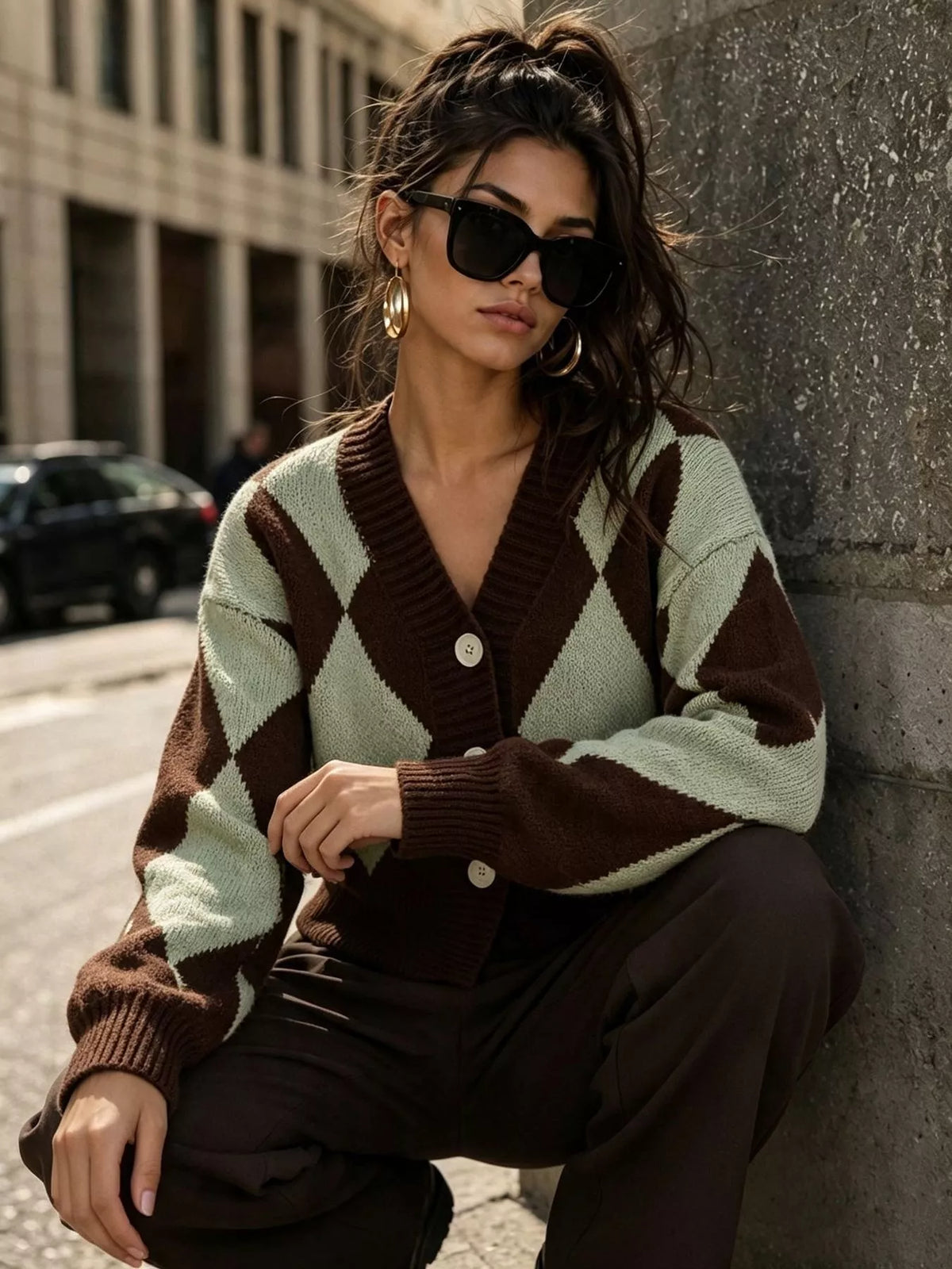 Brown and green argyle v-neck button-front cardigan, seated front view.