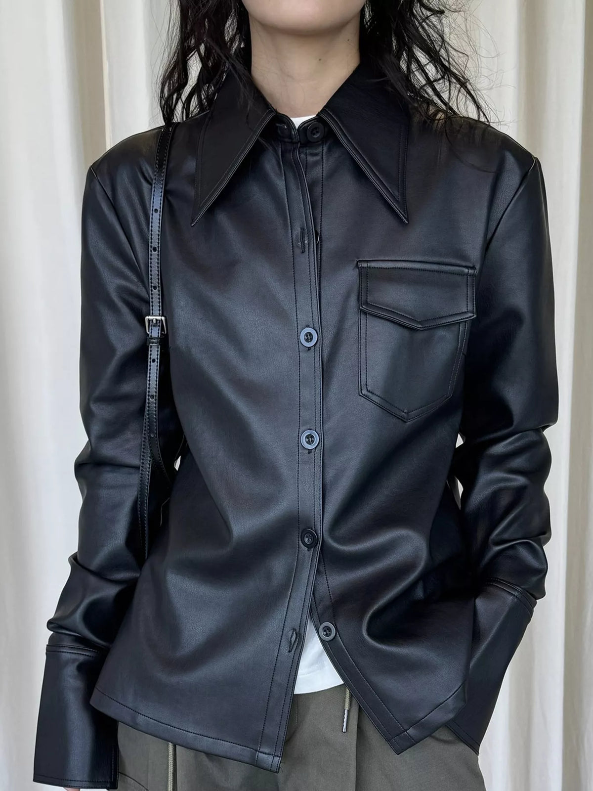 Black faux leather button-front jacket — front view