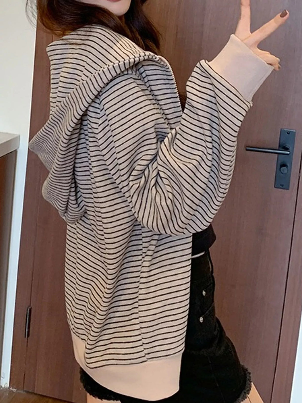 Cream and gray striped zip-up hoodie, side view