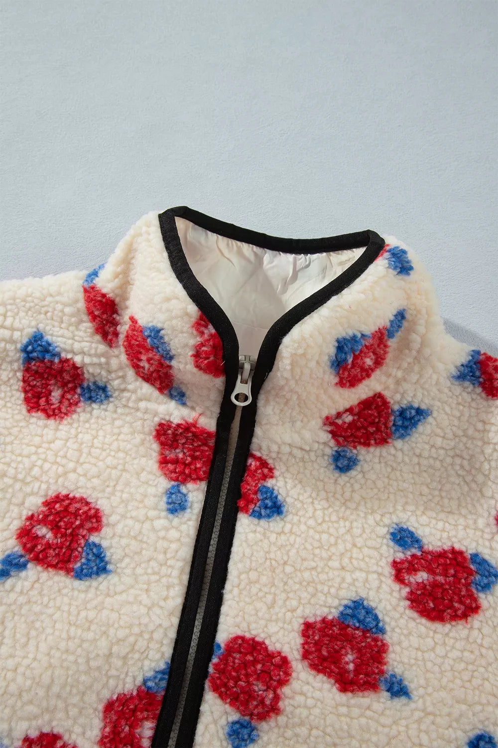 Cream with red flowers floral zip-up fleece jacket, stand collar and zipper detail.