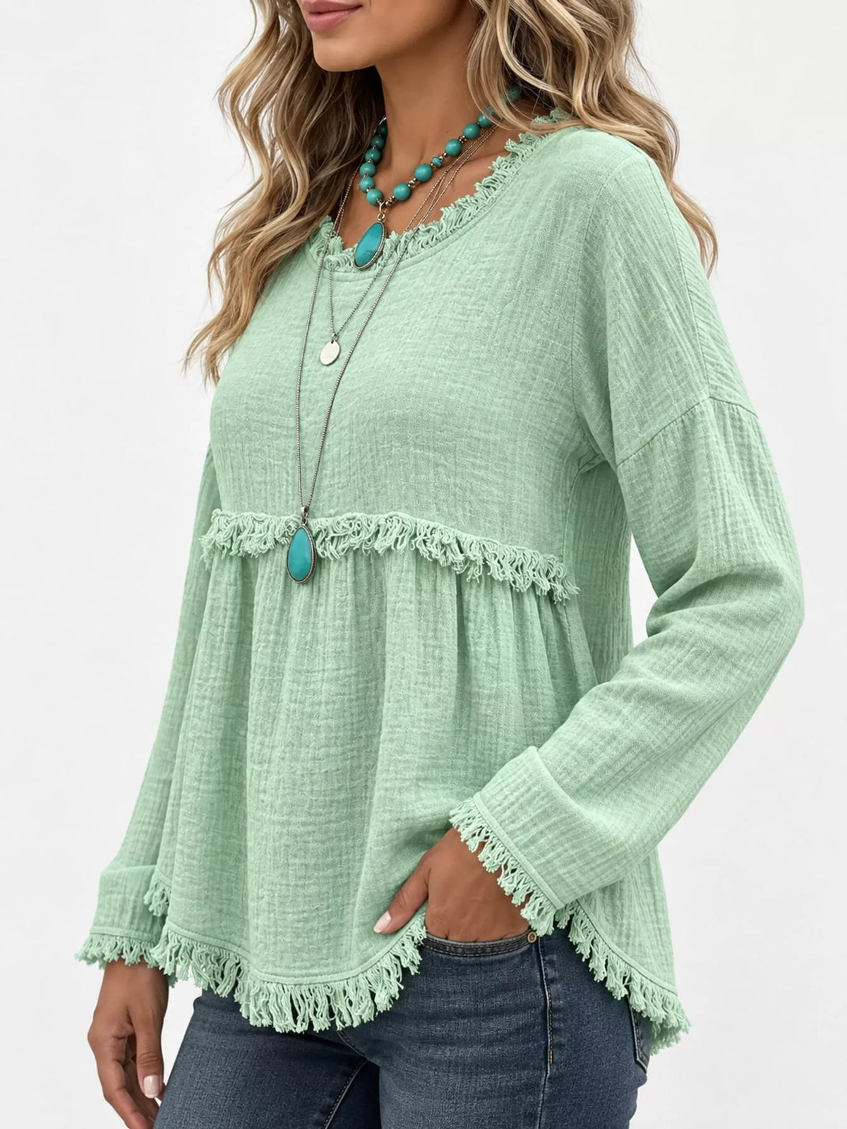 Pale green frayed hem textured blouse, side view