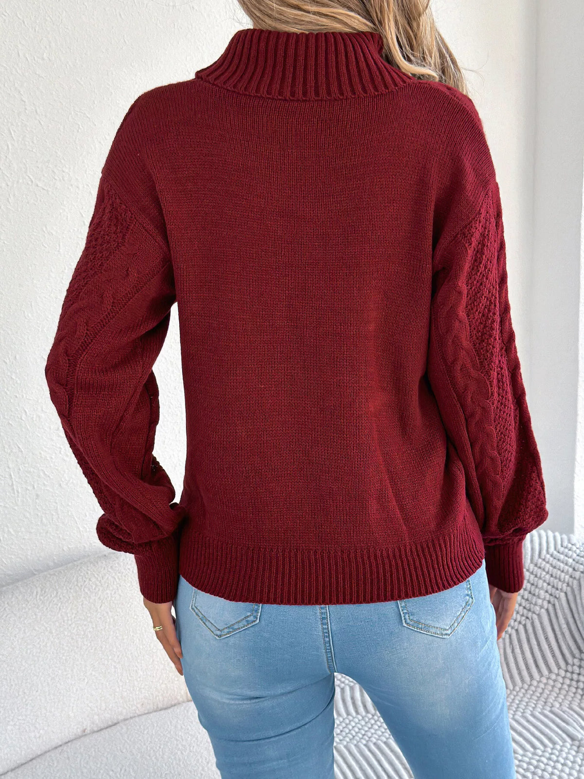 Burgundy turtleneck cable knit sweater, back view