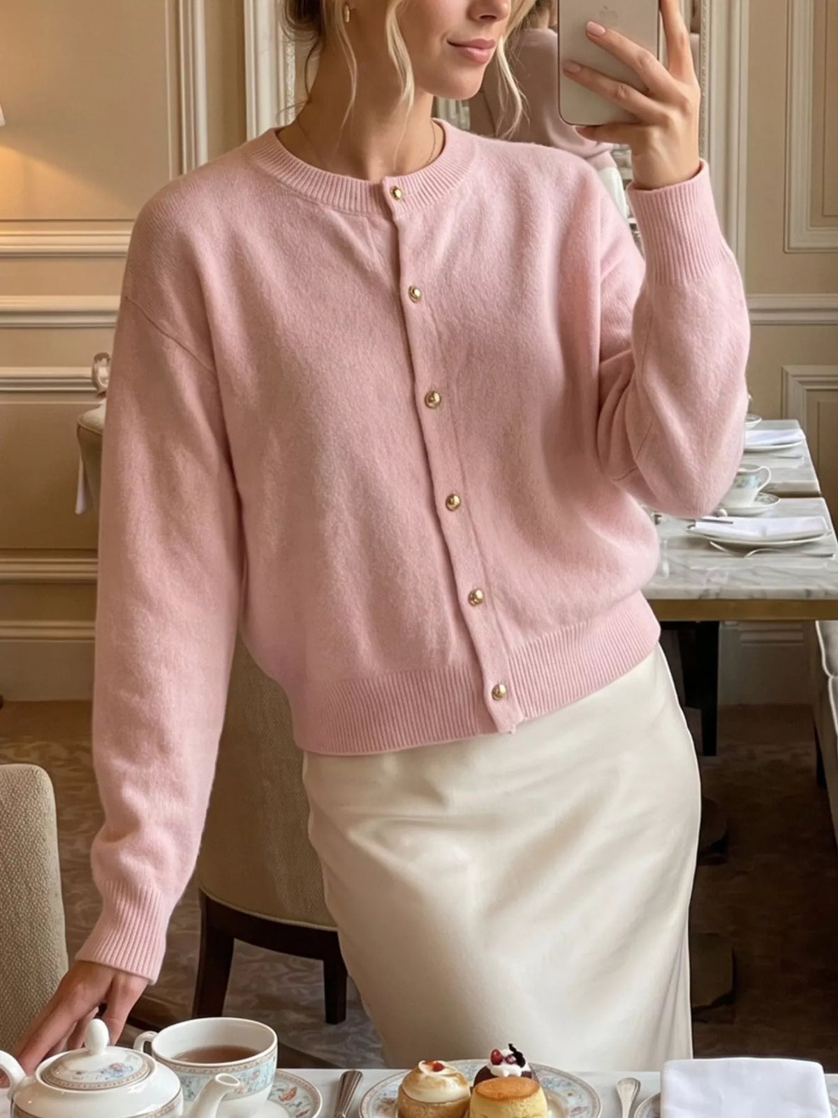 Pink round-neck button-front knit cardigan, front view showing long sleeves.