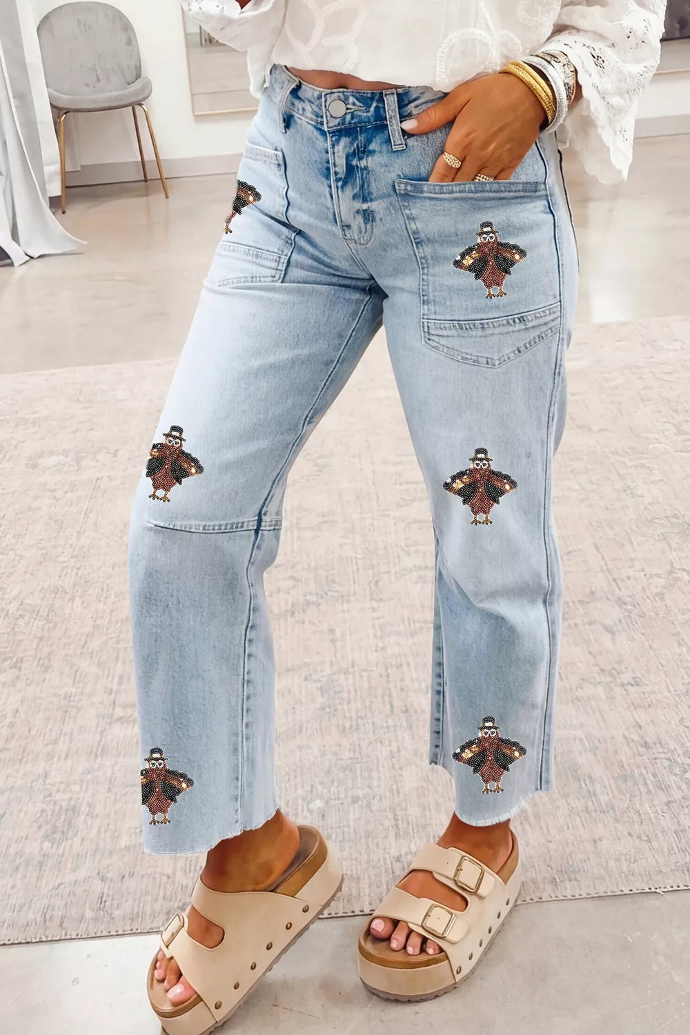 Light blue sequin turkey raw-hem ankle jeans, front view showing turkey sequins.