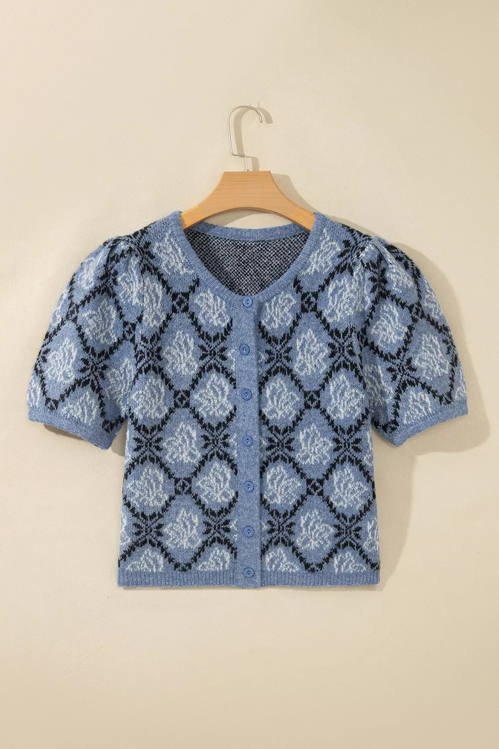 Blue geometric short sleeve cardigan, front on hanger