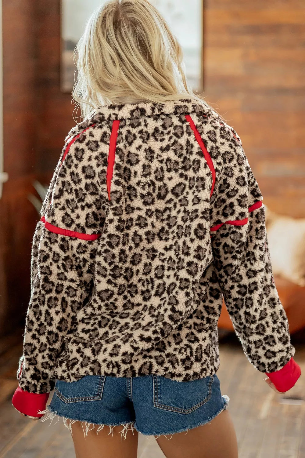Leopard leopard half-zip sweatshirt with red trim, back view.