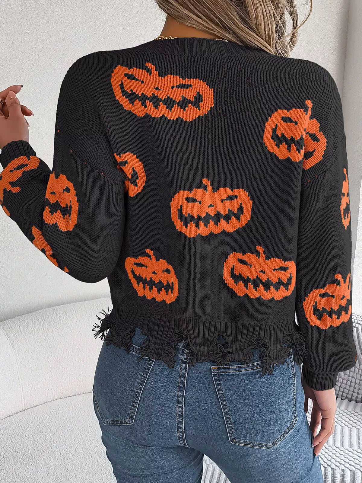 Pumpkin Distressed Hem Sweater in black, back view