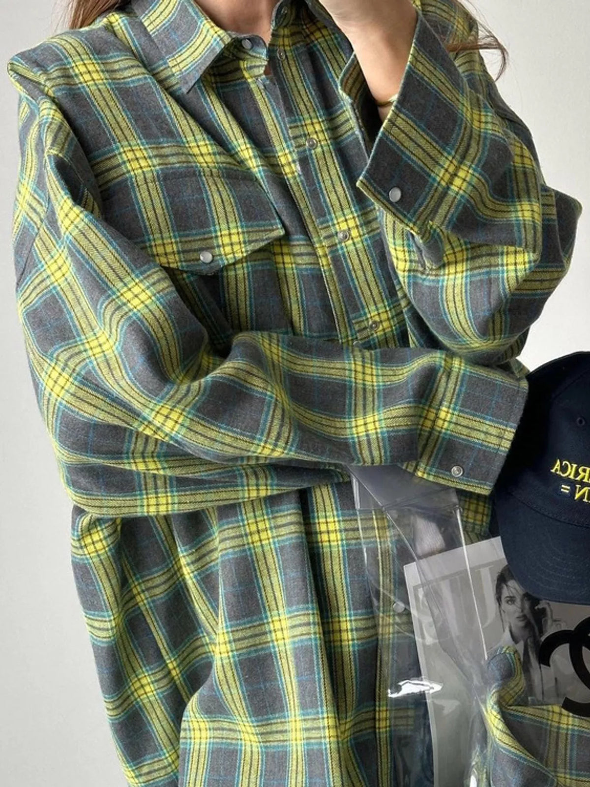 Green and yellow plaid button-down shirt, plaid collar, chest pocket, and sleeve