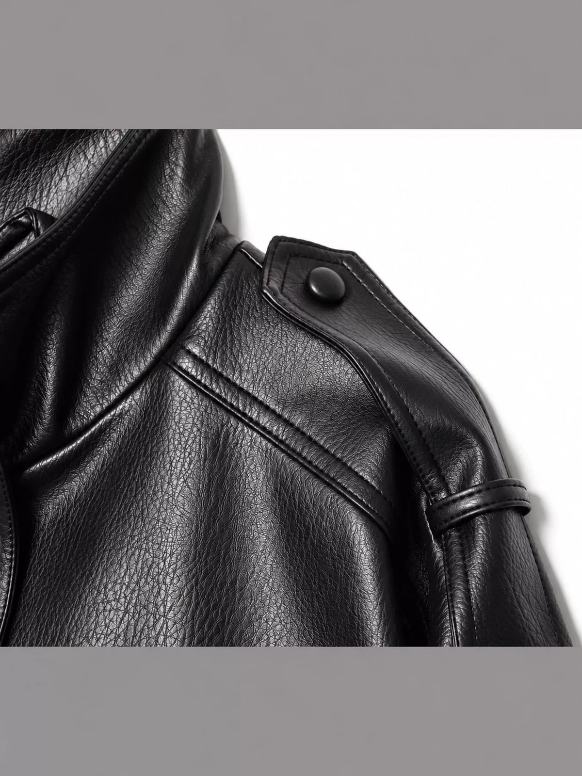 Black faux leather cropped bomber jacket — design and construction details