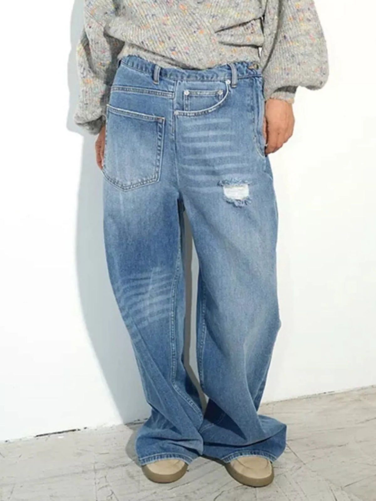 Blue high-waisted distressed wide-leg jeans, angled front view.