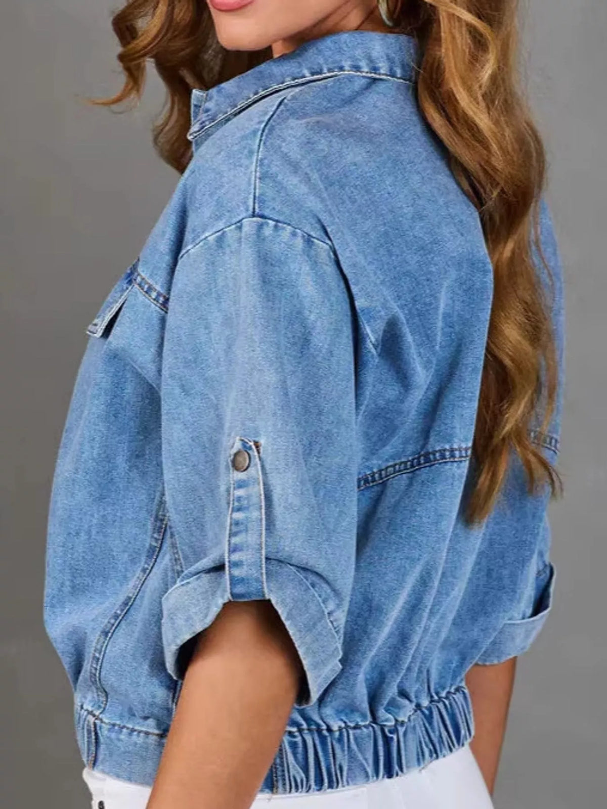 Blue elastic hem denim jacket with roll up sleeves, side view