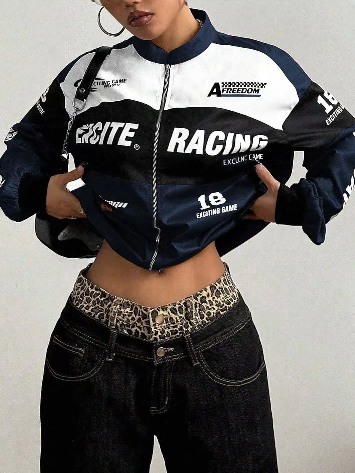 Navy and white letter-print zip-front jacket, front view with hand at waist