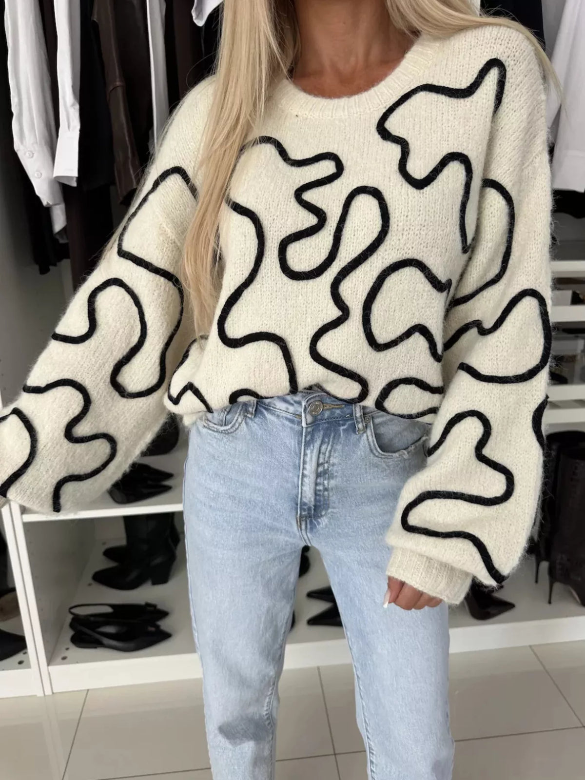 Ivory abstract pattern oversized crewneck sweater, front pattern detail.