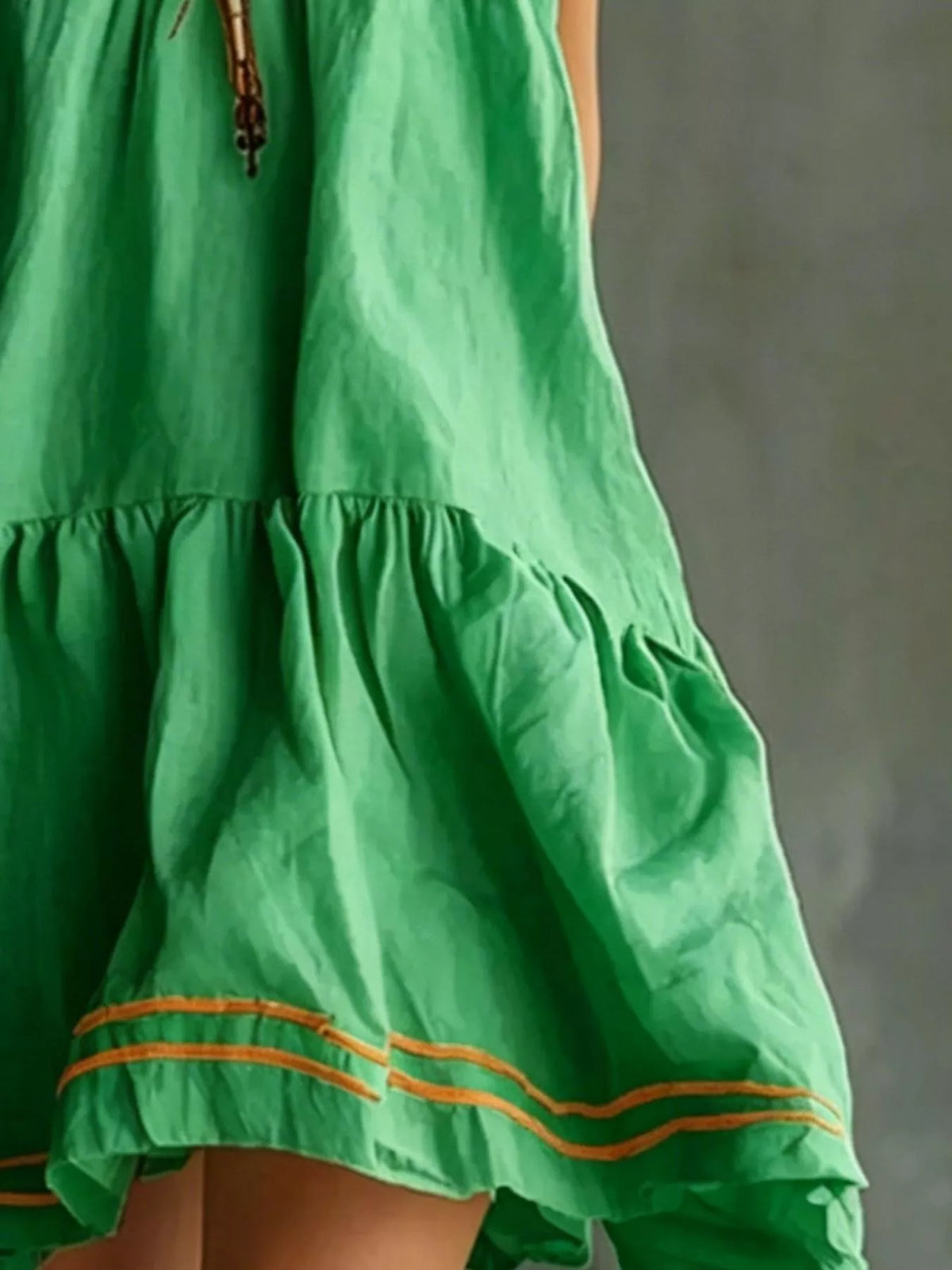 Sleeveless Tiered Mini Dress in green, hem detail