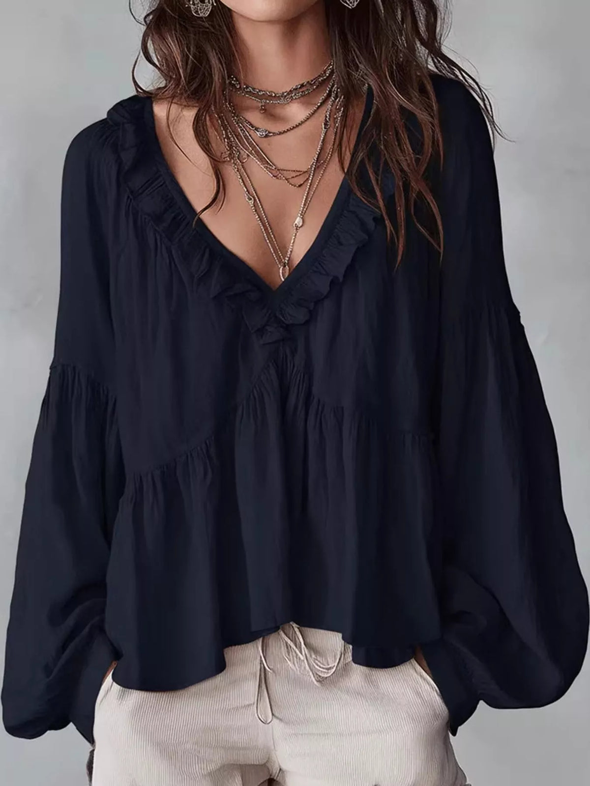 Navy blue ruffled v neck blouse, front view