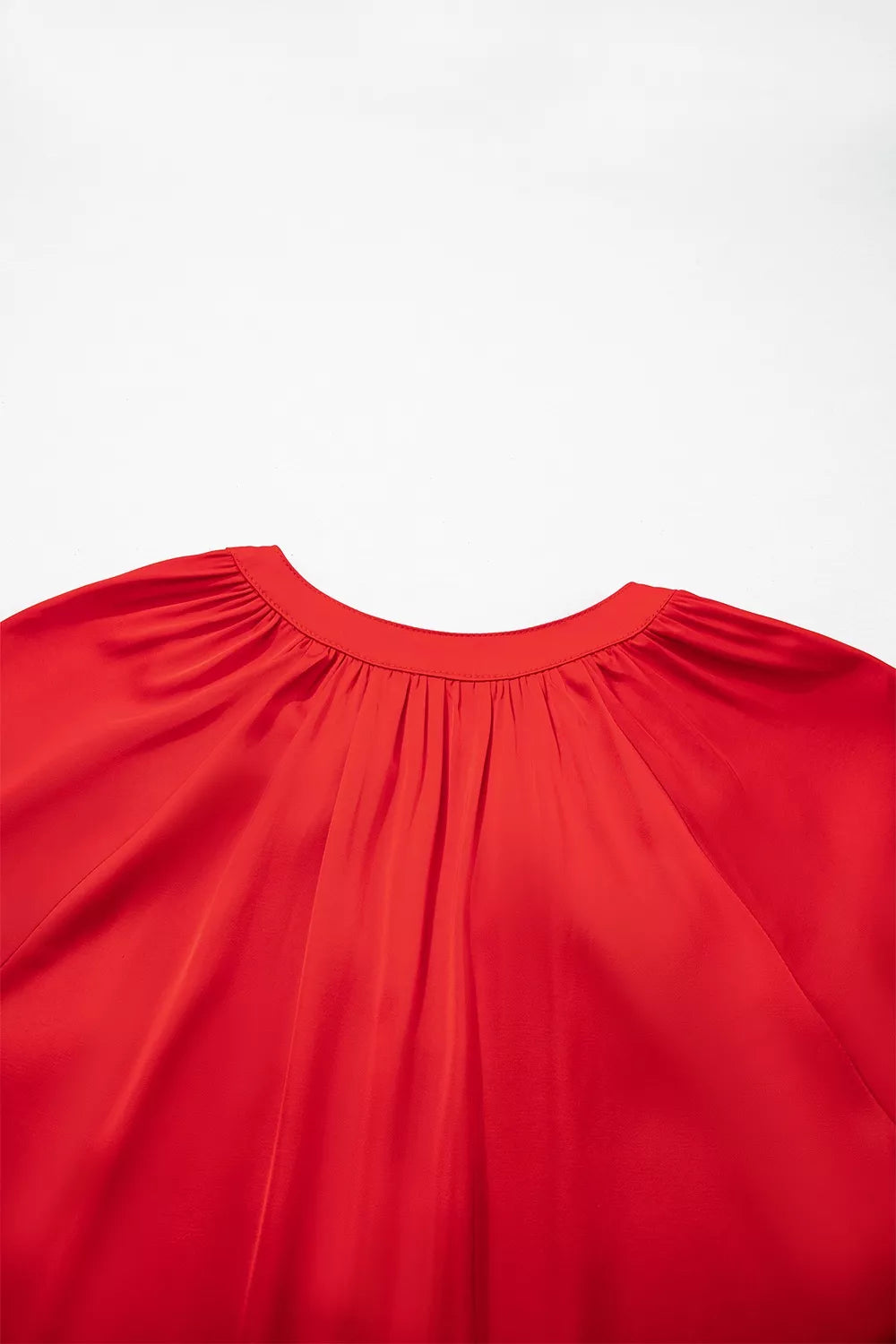 Red lace-panel v-neck button-front shirt, gathered back neckline detail.