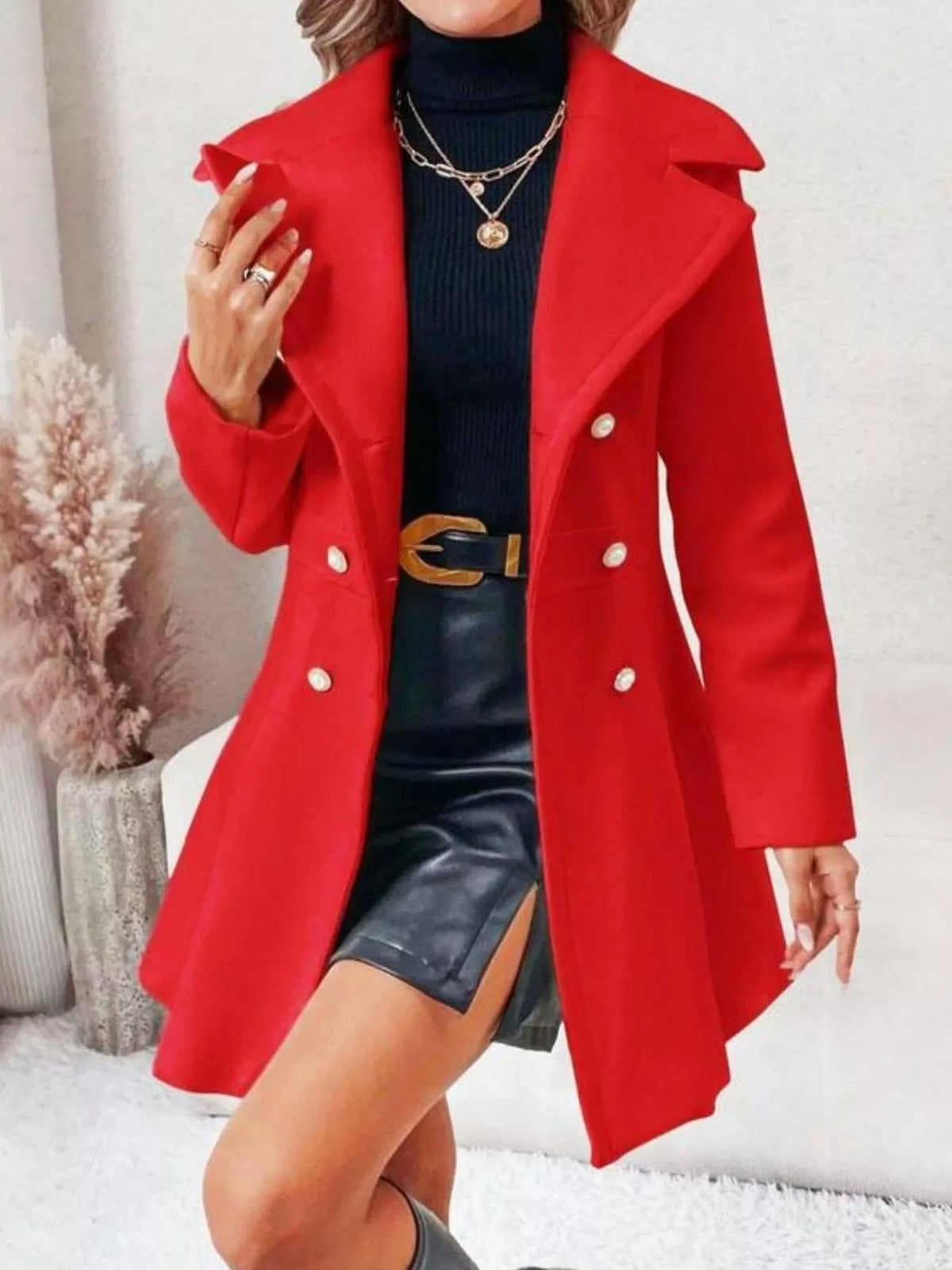 Red double-breasted peplum coat, open front view with hand at lapel